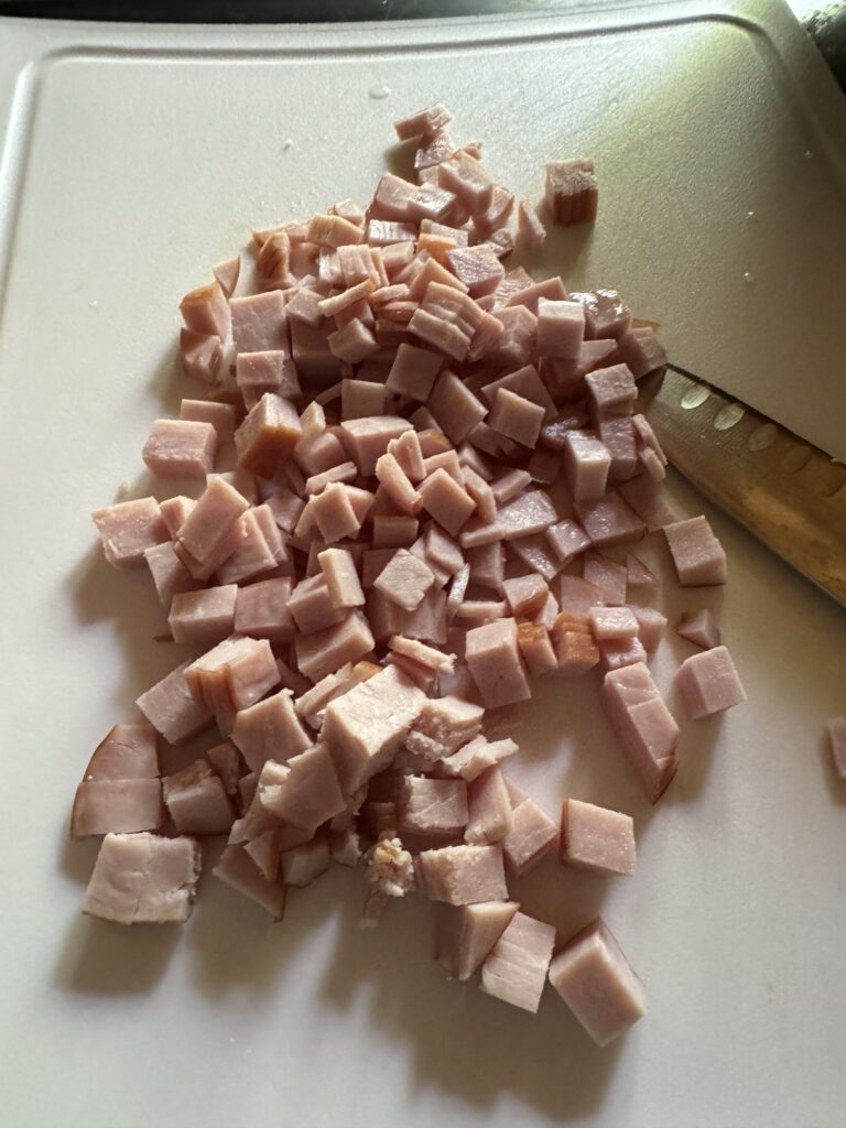 Sliced Canadian bacon on a cutting board.