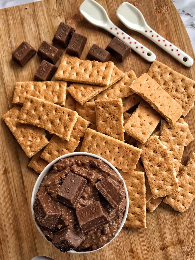 Kit Kat Crunch dip with graham cracker pieces and two white spoons.