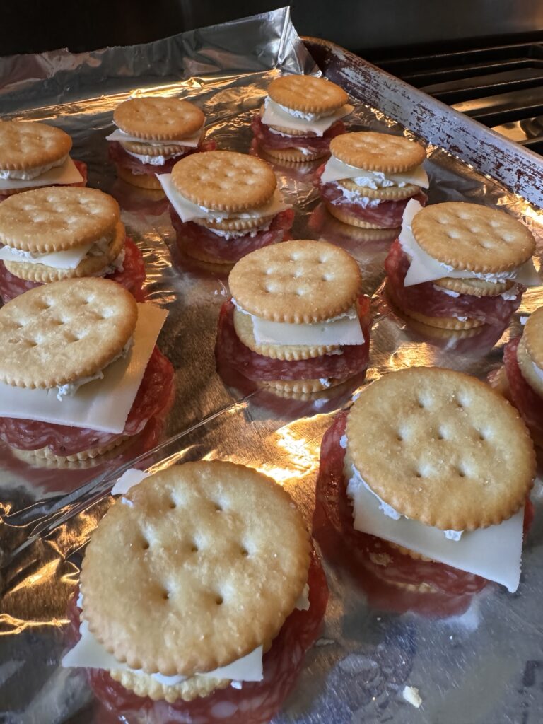 The cracker snacks on a baking sheet before going in the oven.