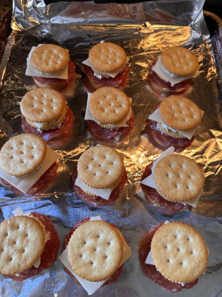 The cracker snack spread out on a baking sheet before being baked.