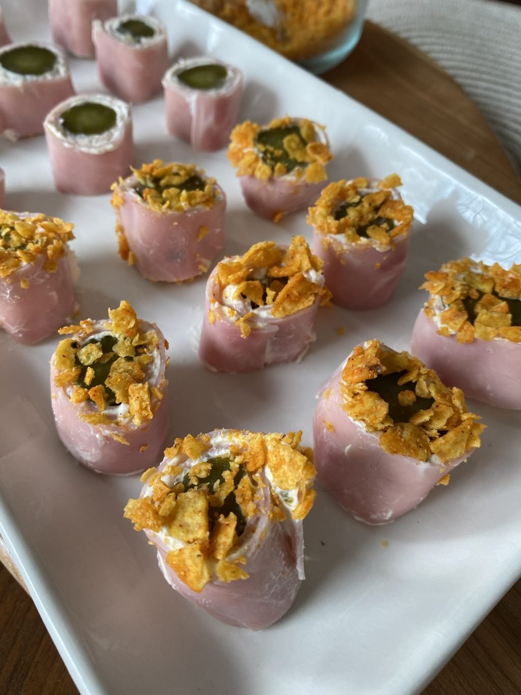 Polish ham roll ups with crushed Doritos on top.