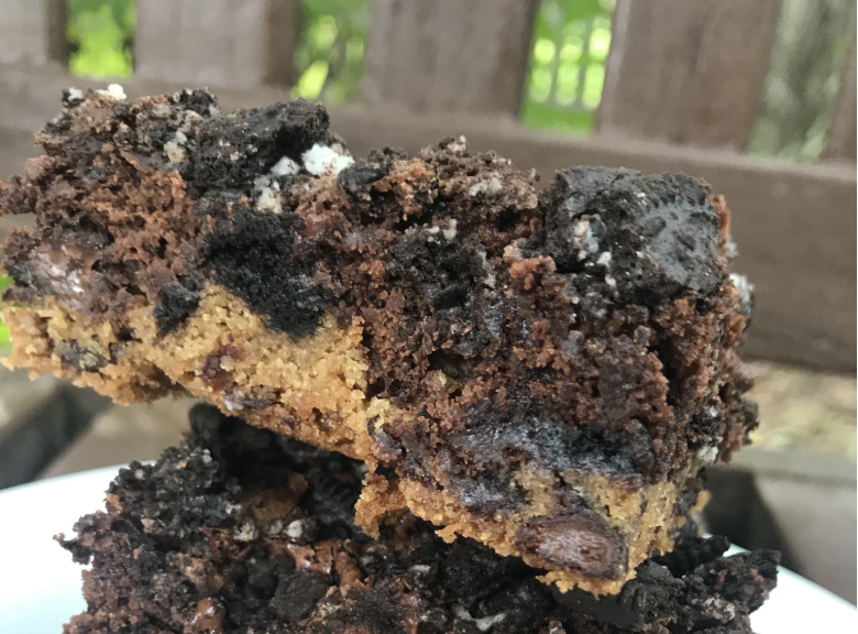 A close up image of a three layer brownie.