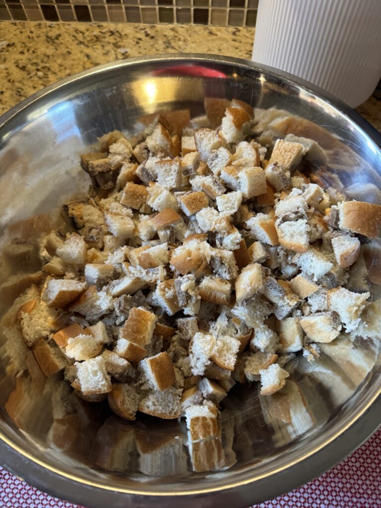 Diced White Castle sliders in a metal mixing bowl.