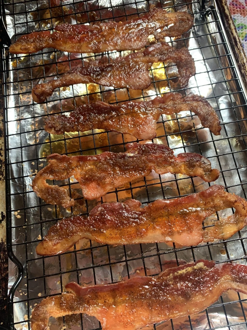 Candied bacon on a metal grate.