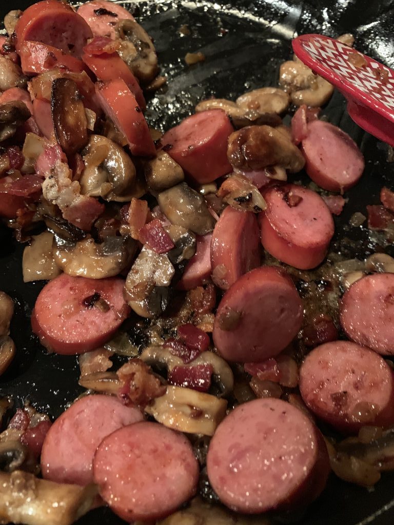 Mushrooms and sausage being mixed together