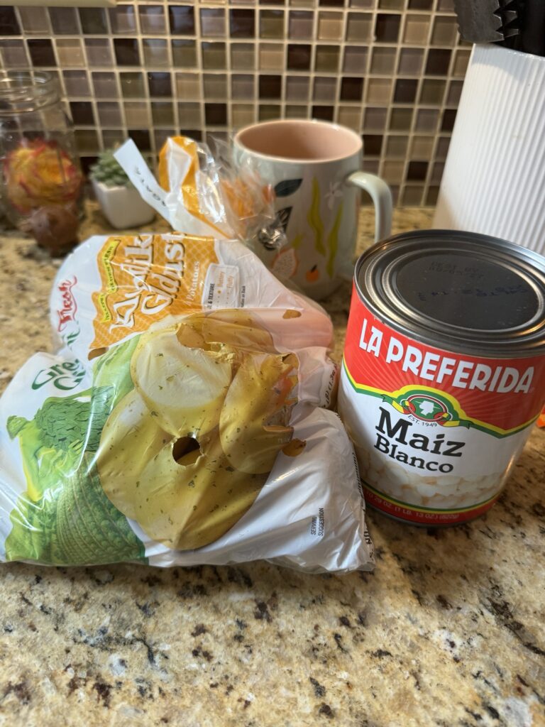 A sack of potatoes next to a can of maiz blanco corn