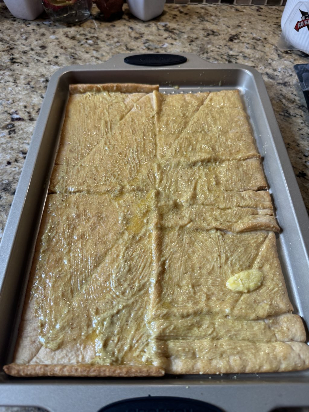 Mustard spread on crescent roll dough