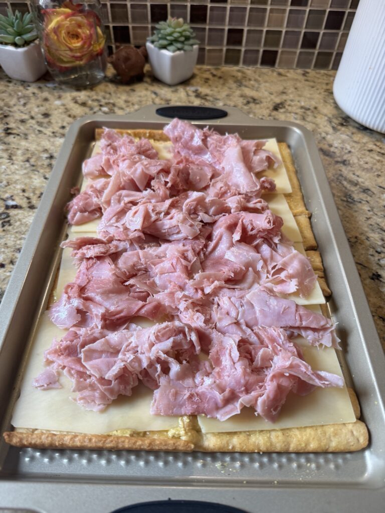 Shaved deli ham and cheese on cooked crescent dough