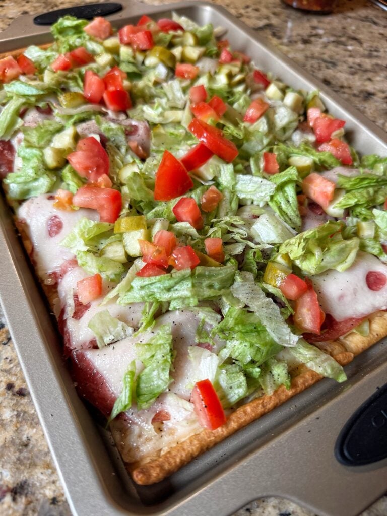 Flatbread topped with deli meats and veggies.