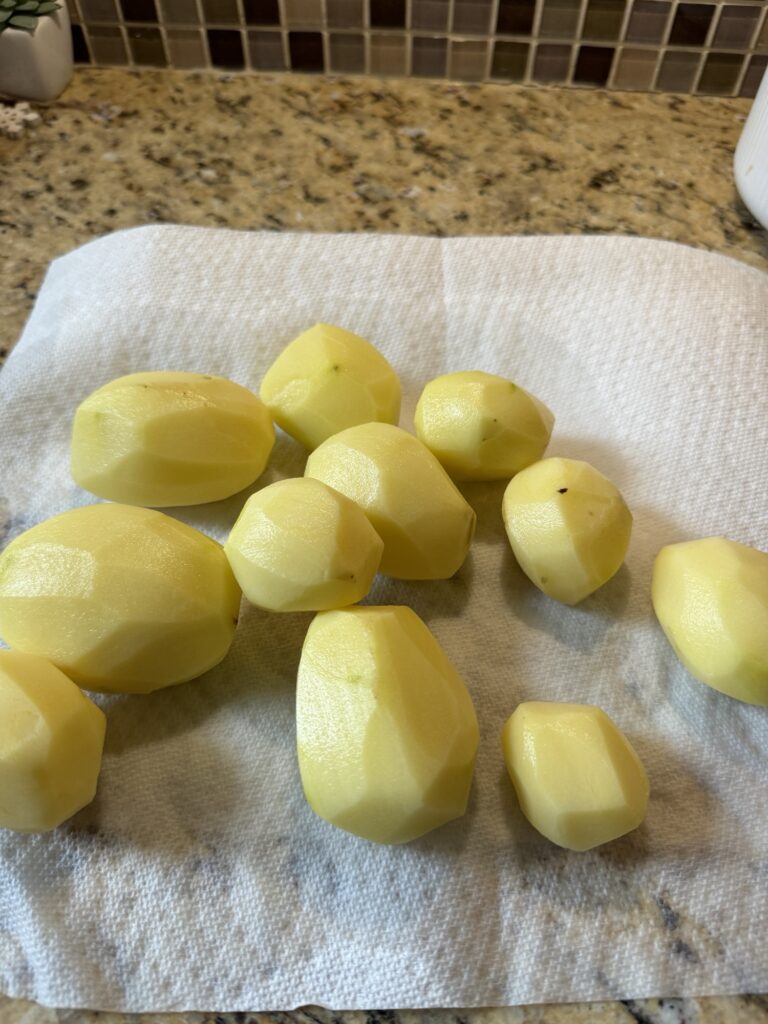 Peeled potatoes on a paper towel