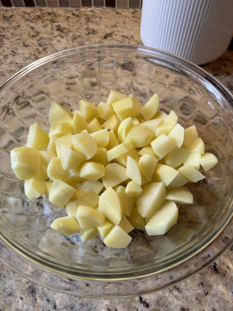 Cut up potatoes in a glass bowl