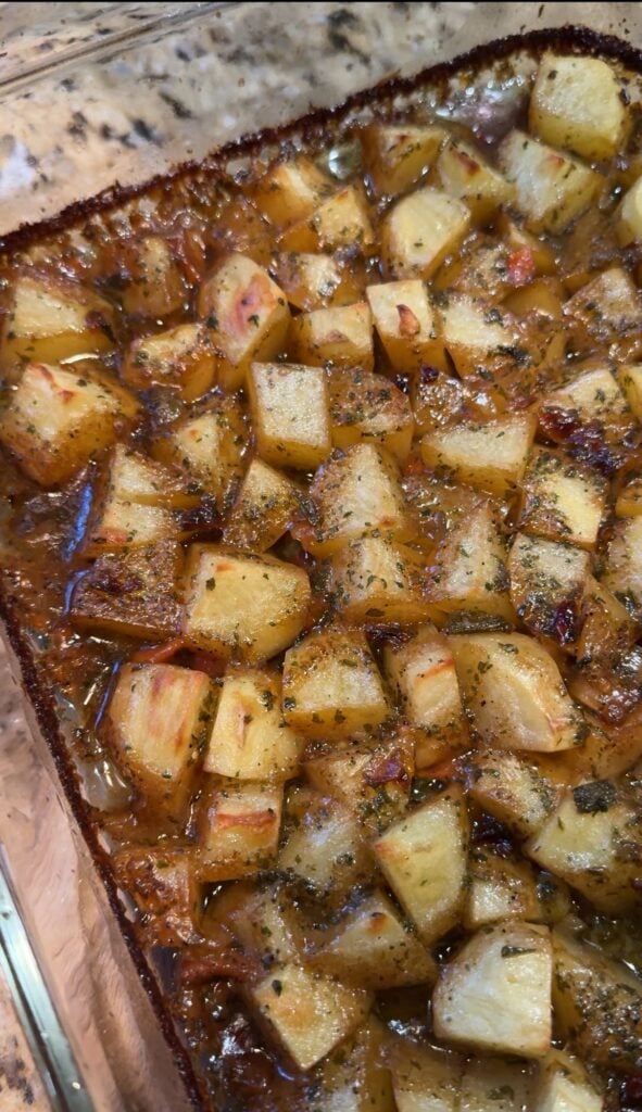 A glass dish with baked breakfast potatoes