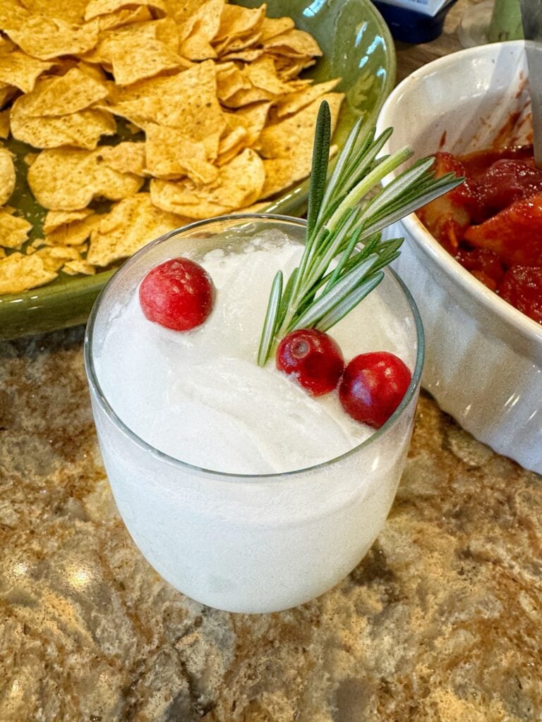 The "Snow Day" cocktail topped with rosemary and cranberries