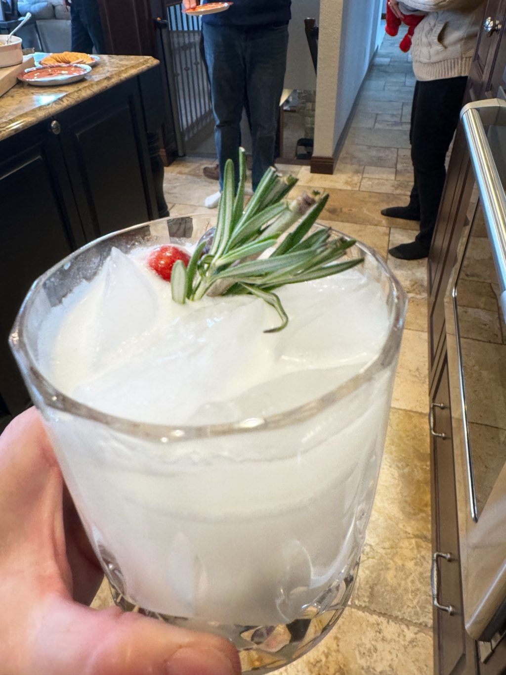 The "Snow Day" cocktail topped with rosemary and cranberries