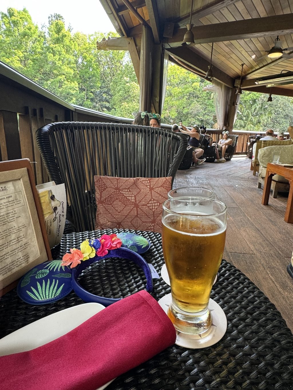 A view of the patio of Nomad Lounge with a beer in the foreground.