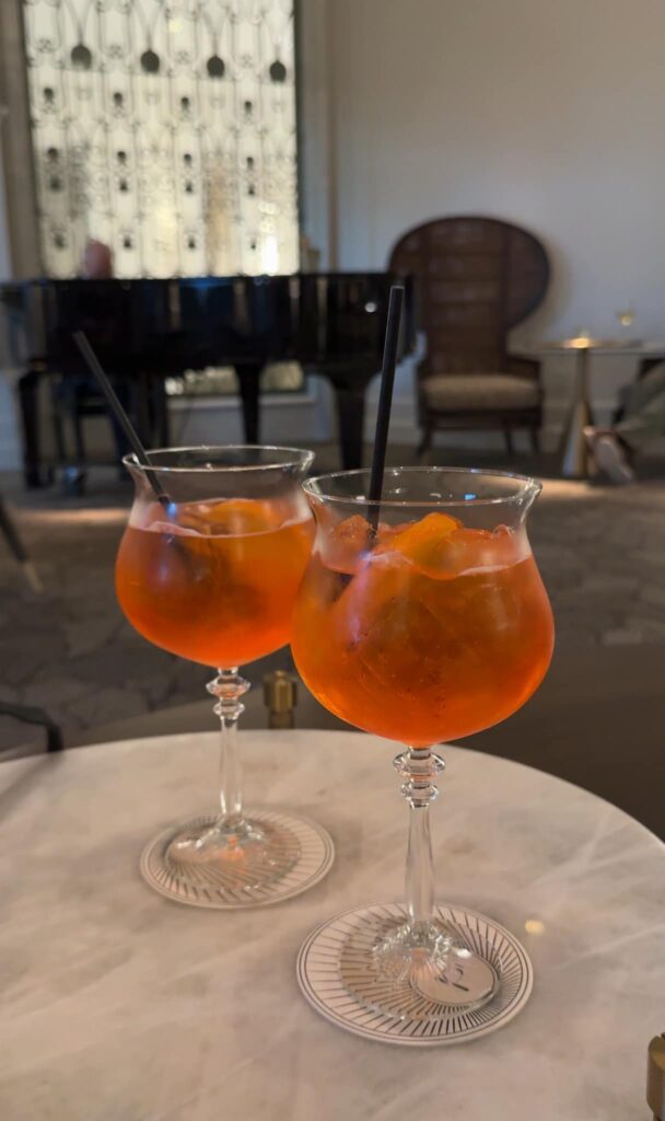 Two Aperol Sprtiz drinks on a table at the Peacock Alley