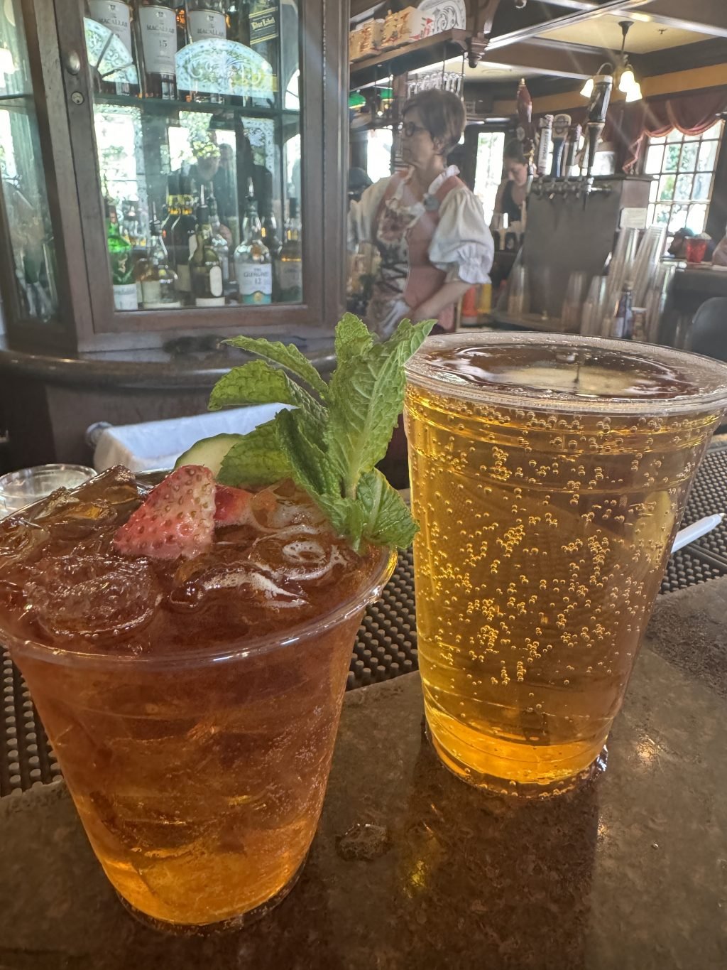 A Pimm's Cup and a beer on the counter at the Rose and Crown Pub