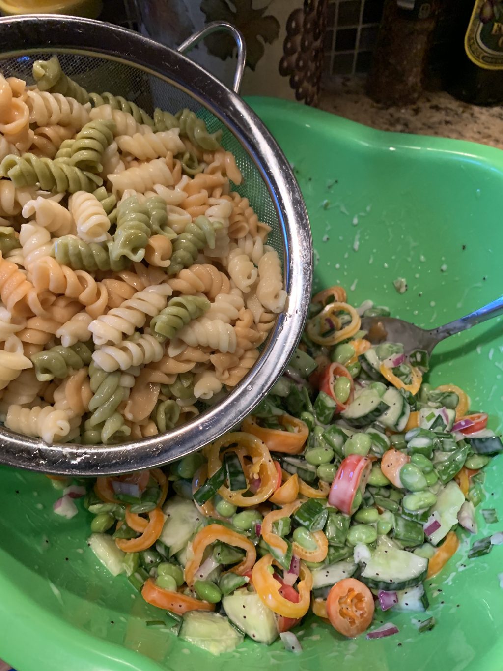 Pasta being added to veggies