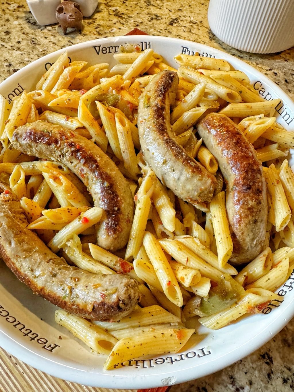 A bowl of sausages and penne pasta