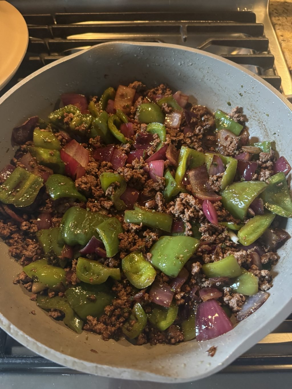 Beef, peppers, and broccoli cooking in a pot