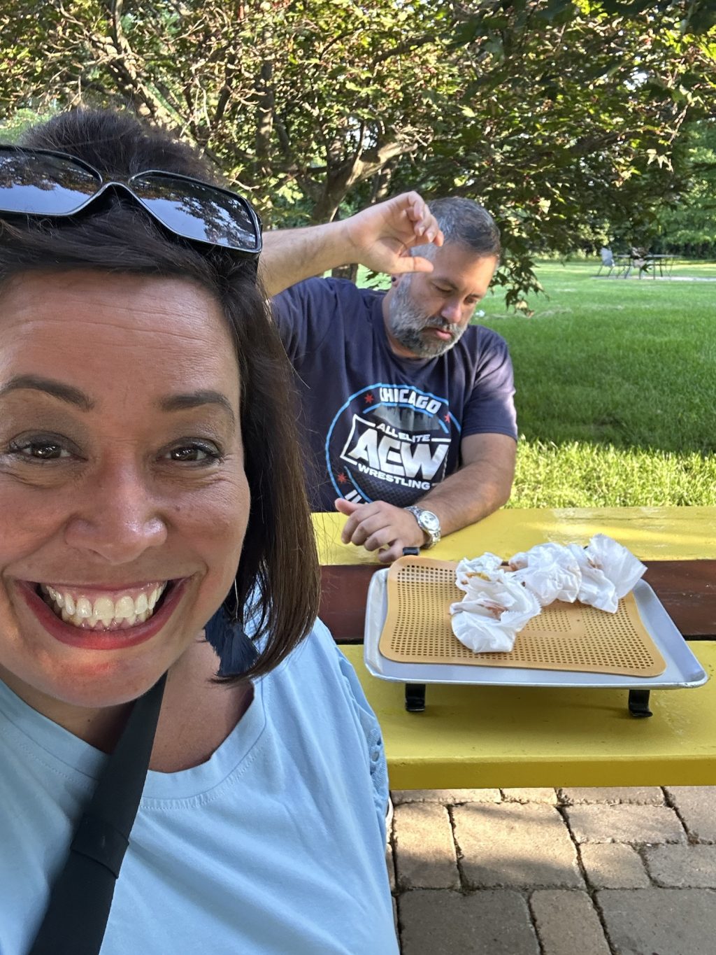 The mister and me enjoying our Coney Dogs on a picnic table