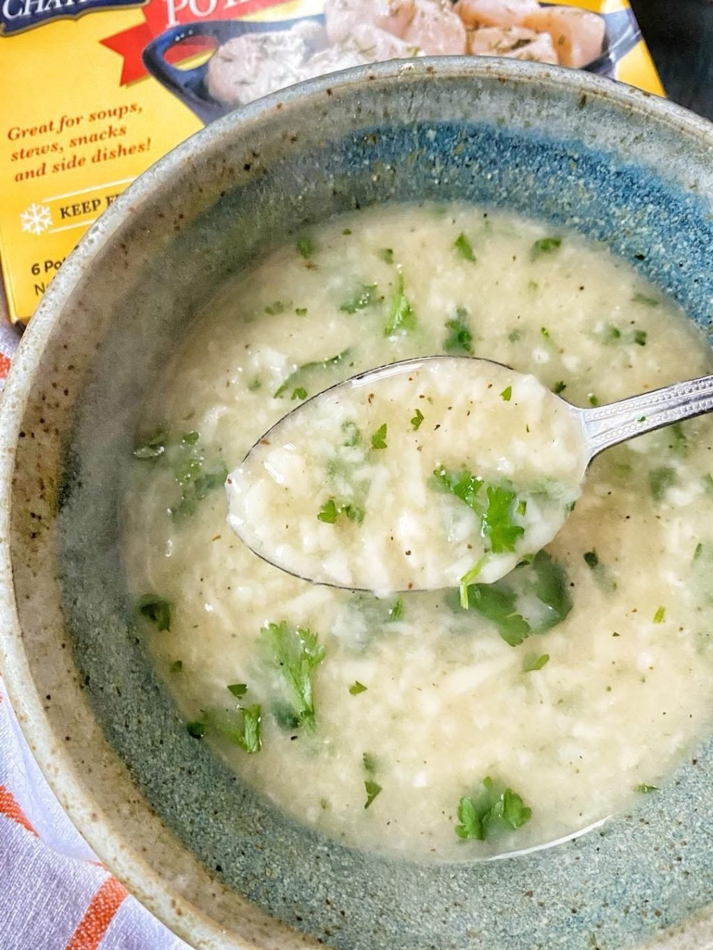 Dumpling soup with a spoon being raised from it
