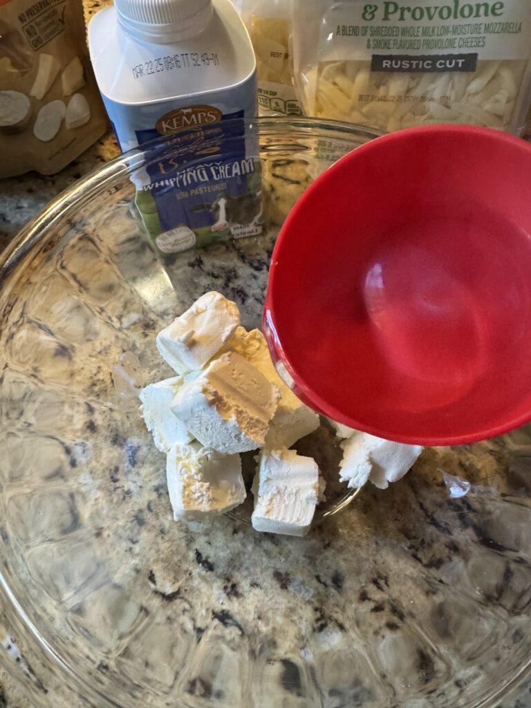 Cubes of cream cheese in a glass bowl