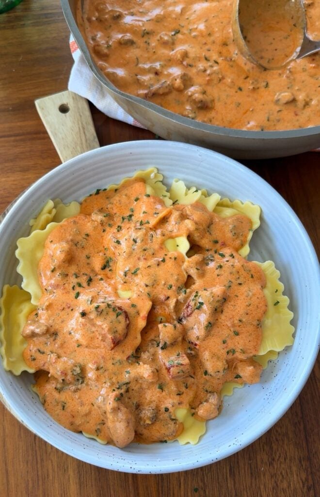 A bowl of ravioli with pink ravioli sauce