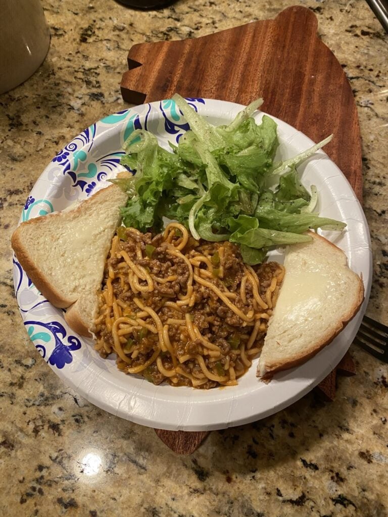 Spaghetti with bread and salad