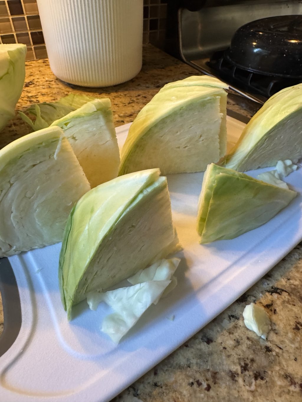 Quartered cabbage heads on a cutting board