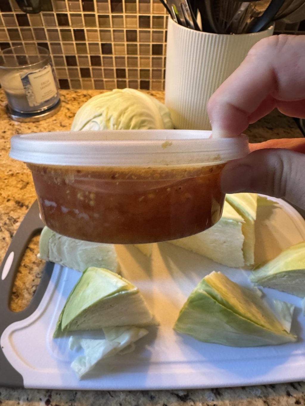 A plastic container of drippings