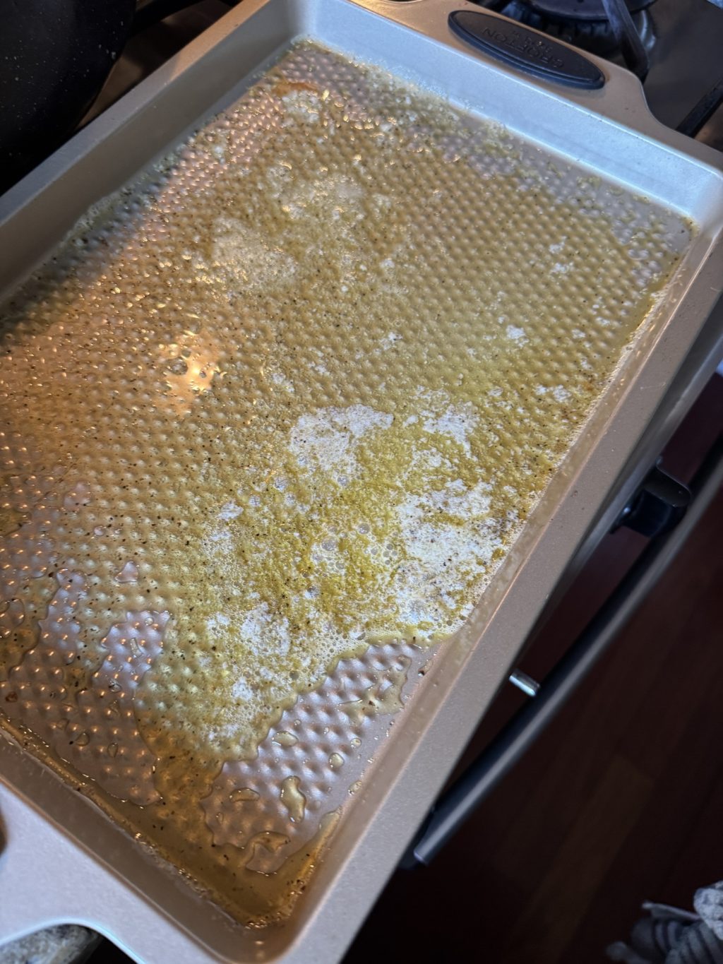 Melted butter on a baking pan