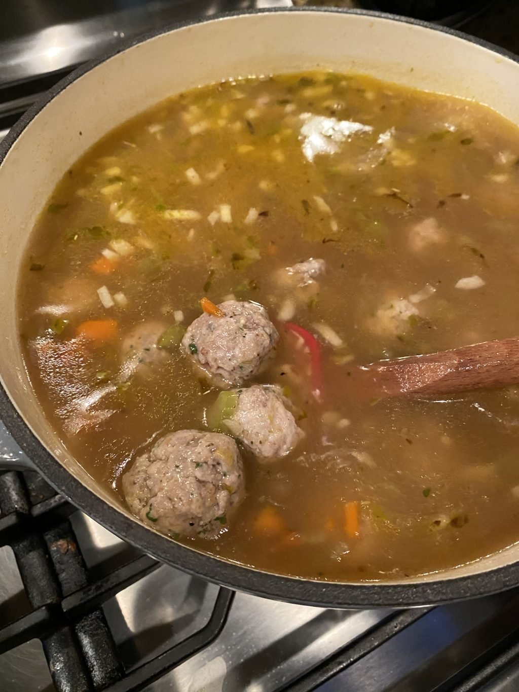 Meatballs simmering in soup