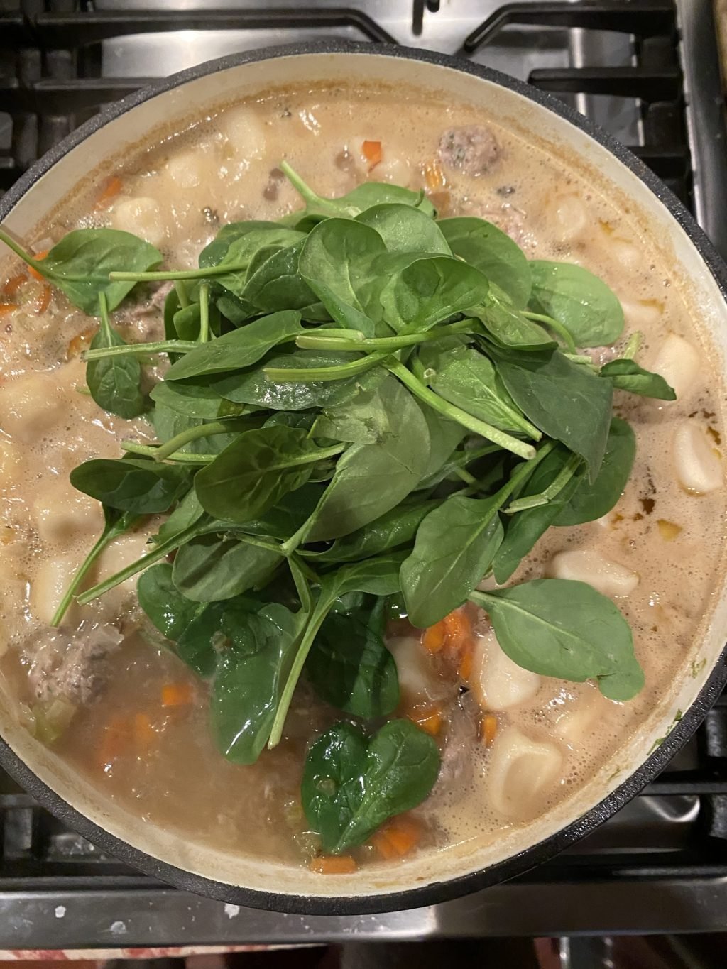 Spinach on top of the wedding soup