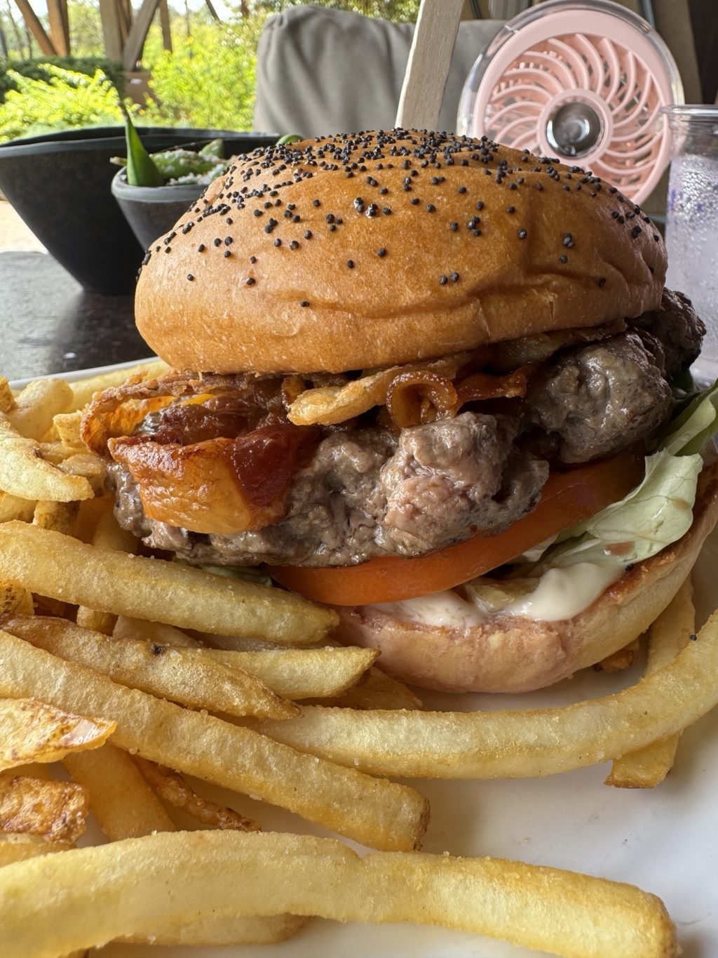 A burger with bacon and fries