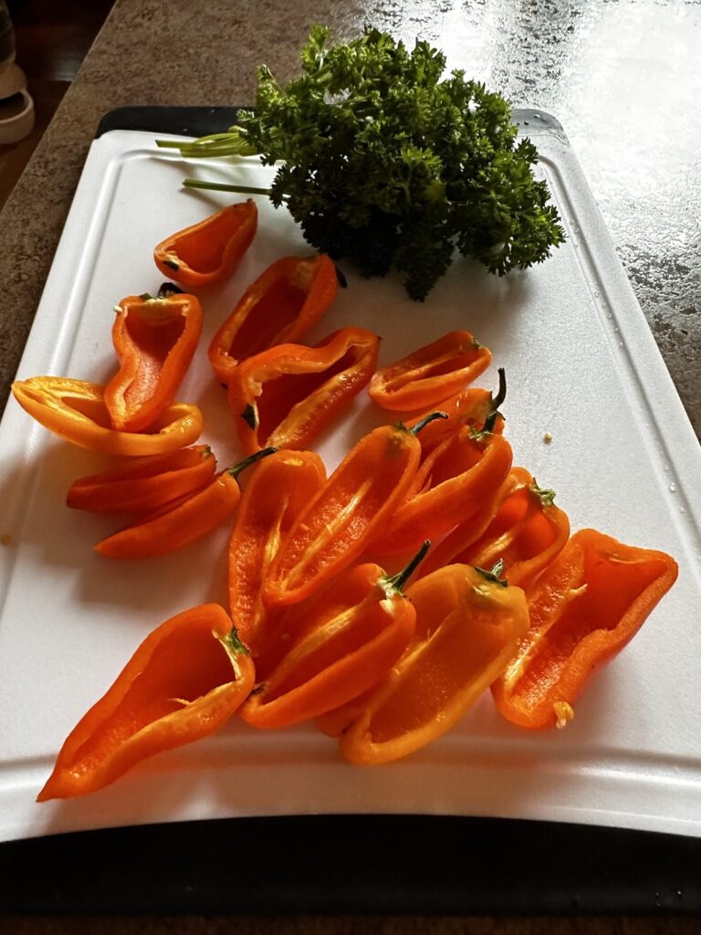 Mini orange peppers sliced in half