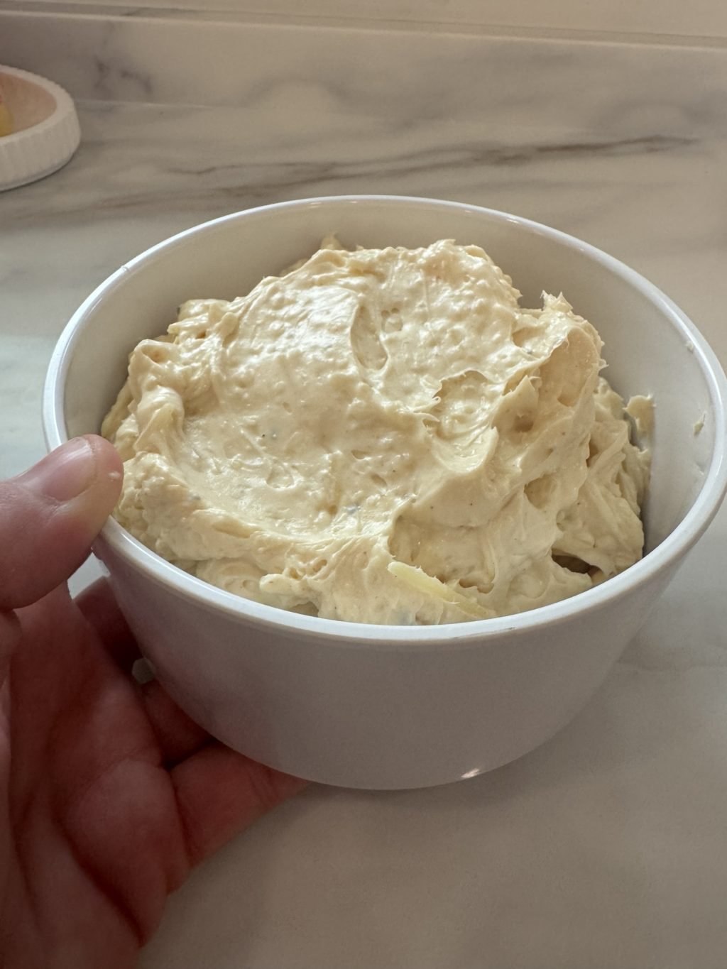 The dip in a bowl before adding the toppings