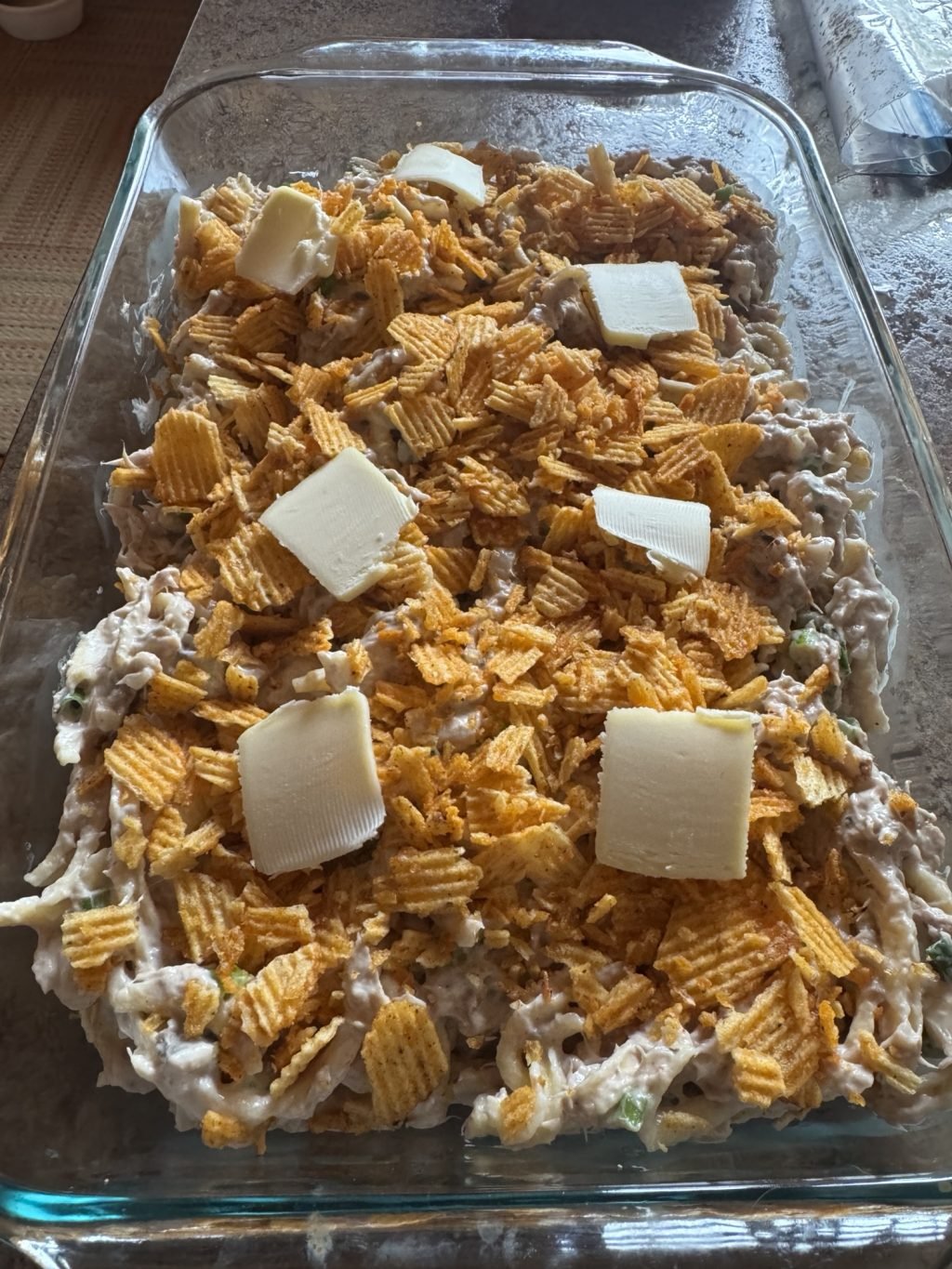 The casserole topped with butter pats