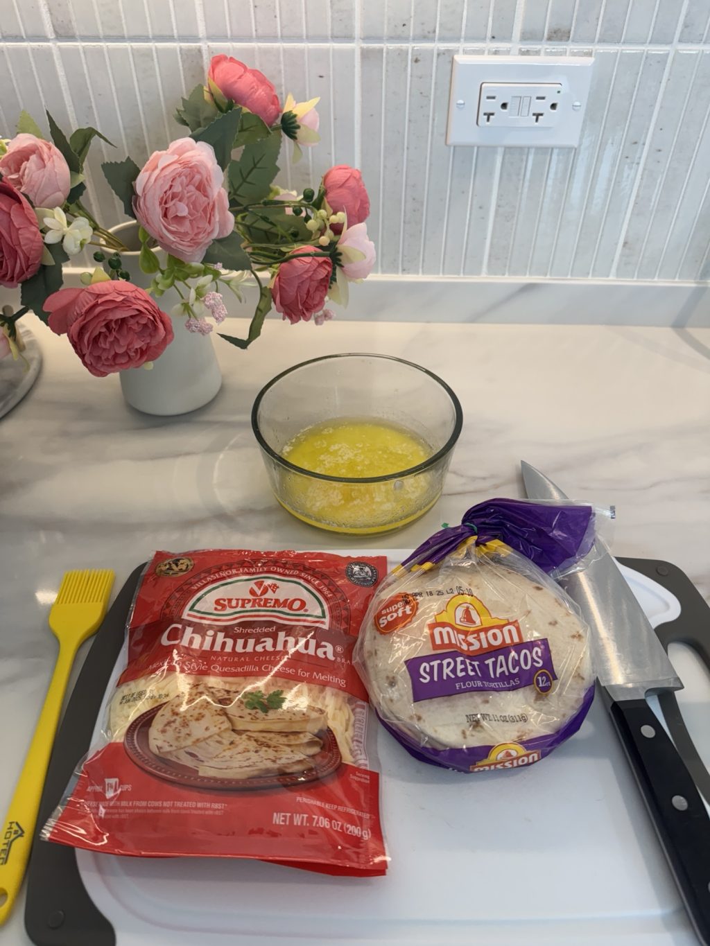 Cheese, tortillas, and melted butter for the quesadillas