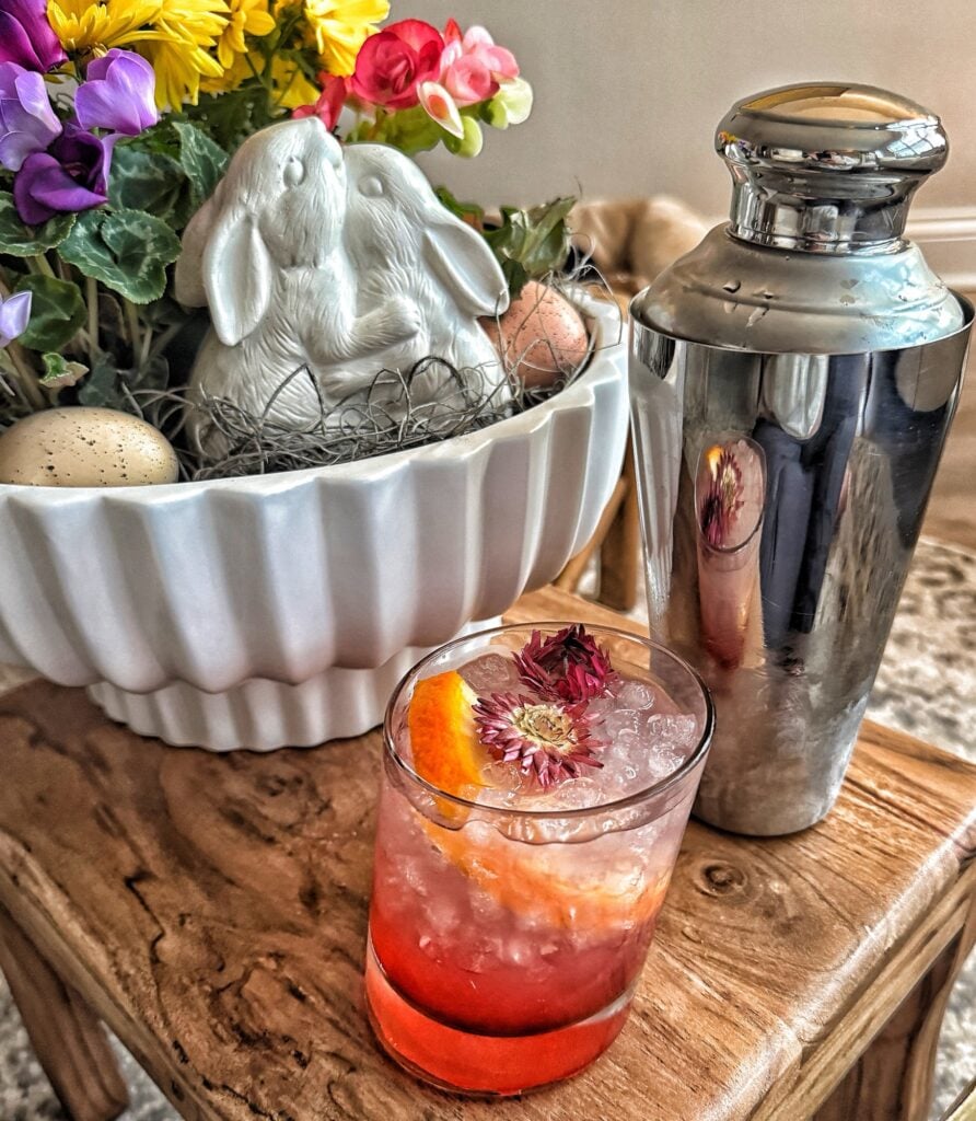 Azalea Cocktail next to a bunny centerpiece and a cocktail shaker