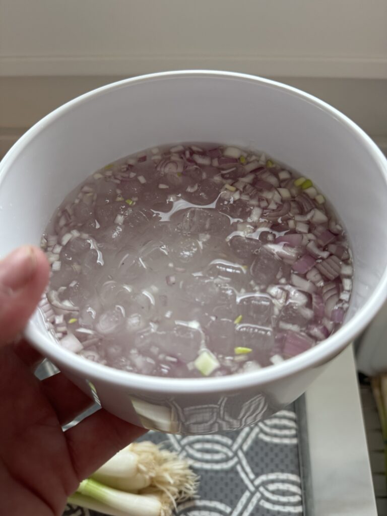 Shallots in an ice bath