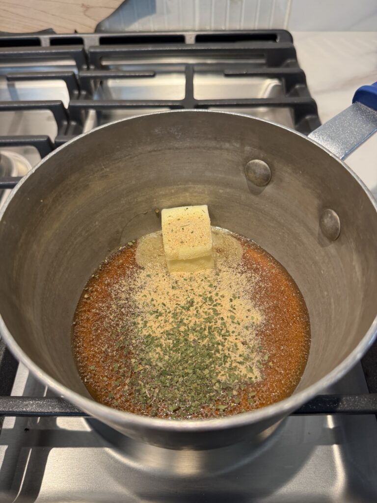 Butter melting in a pot with seasonings