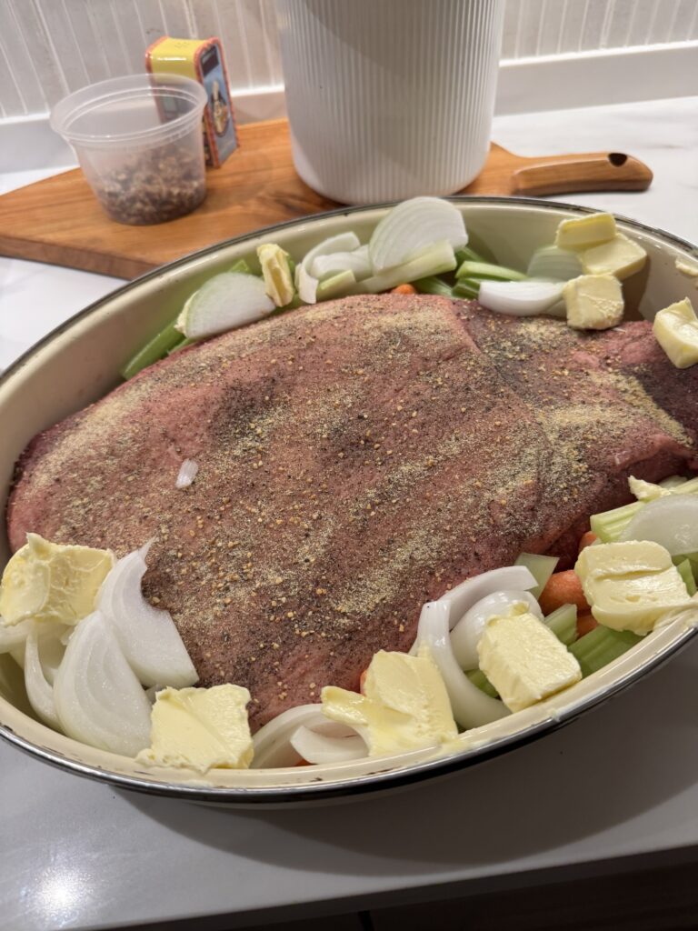 Seasoned brisket with onions, celery, carrots before being cooked