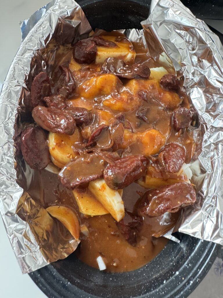 The chili pepper sauce with onions in the black speckled roaster