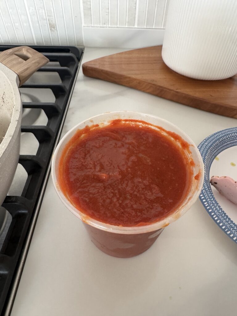 A plastic container of salsa