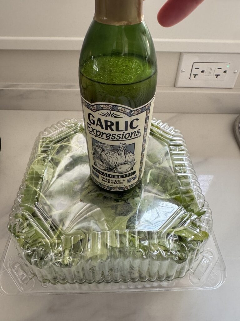 Garlic expressions dressing on a package of arugula