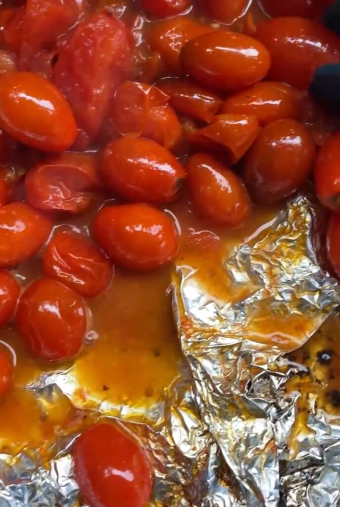 A close up of the cooked tomatoes in the foil pouch