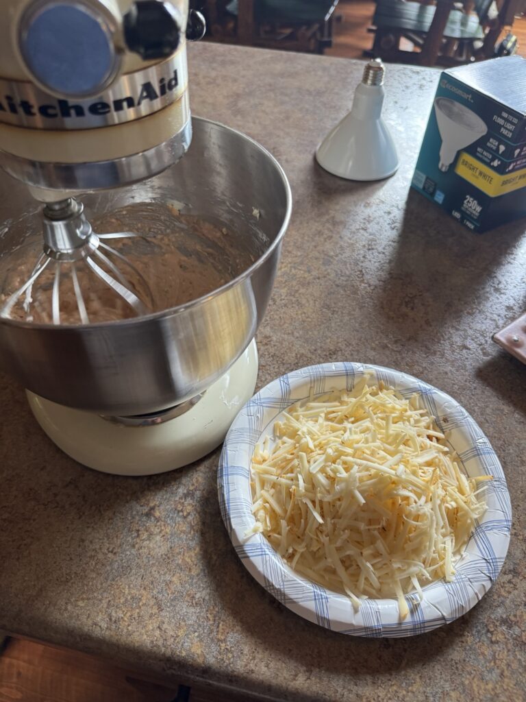 Shredded cheese next to a stand mixer