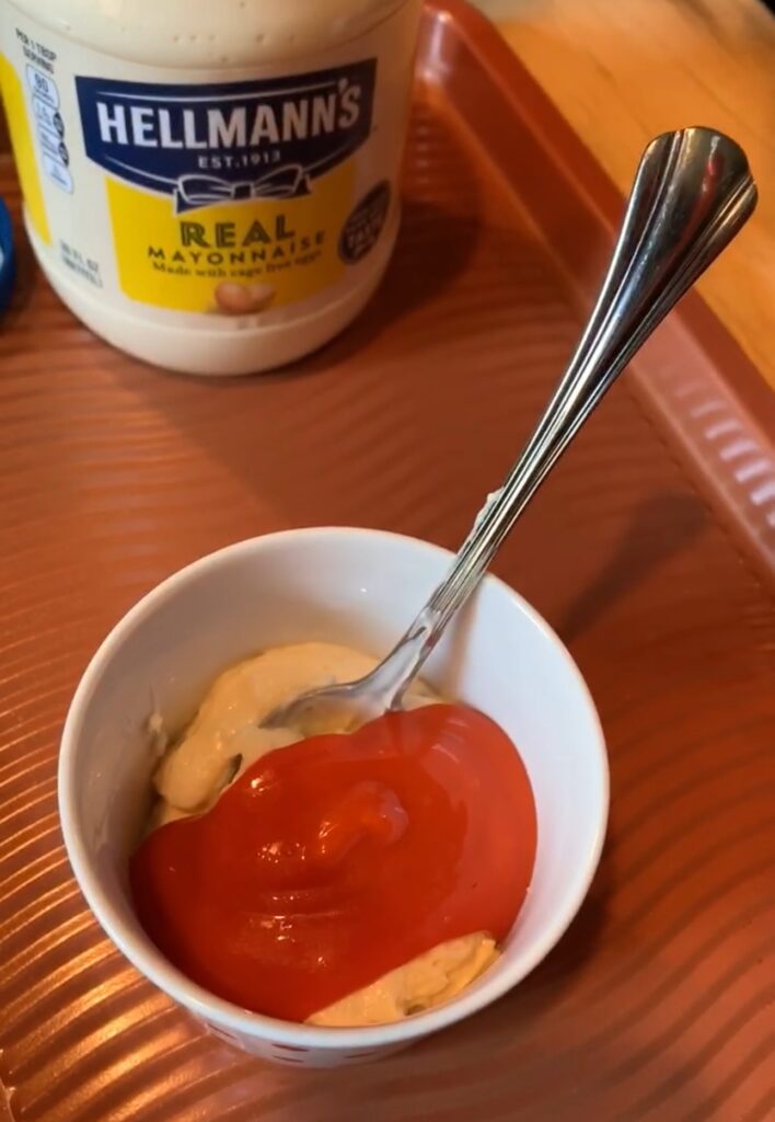 Mayo and dressing in a small cup with a spoon