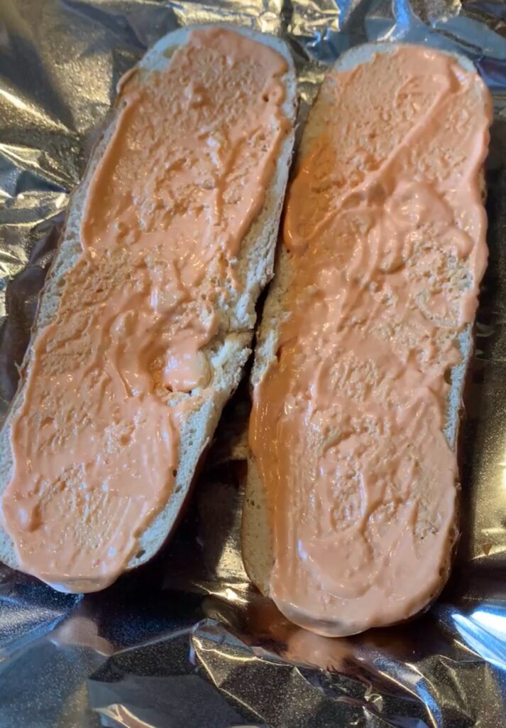 Special sauce spread on the two halves of a split loaf